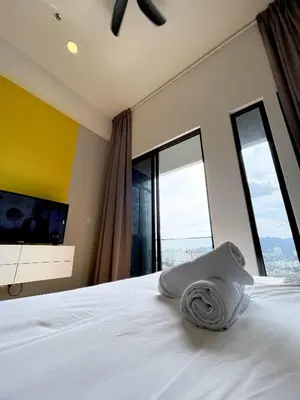 a bedroom with a white bed with large windows at Penang Georgetown KT Home for 8 pax in George Town