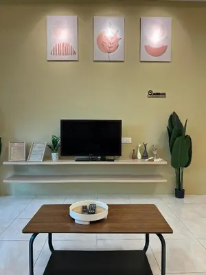 a living room with a tv and a coffee table at The Five Cottage @ Botani Ipoh in Ipoh