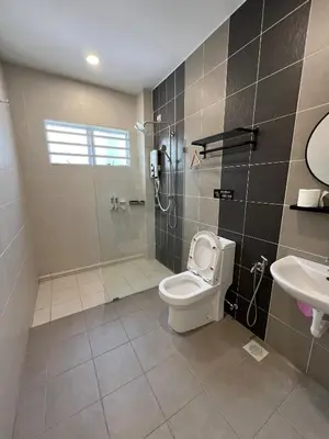 a bathroom with a shower and a toilet and a sink at The Five Cottage @ Botani Ipoh in Ipoh