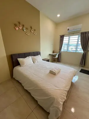 a bedroom with a large white bed and a window at The Five Cottage @ Botani Ipoh in Ipoh