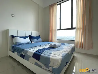 a bedroom with a bed with two towels on it at Ipoh Meru Casa Kayangan 3 Bedroom Apartment in Ipoh