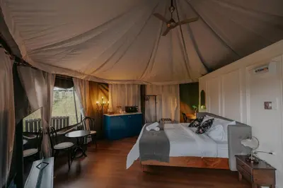 a bedroom with a bed in a tent at kMah@SomerMansion in Tanah Rata