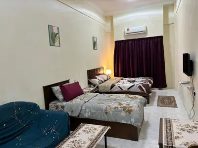 a room with two beds and a couch in it at Sofea Inn Bukit Merah - Laketown A6116 in Simpang Ampat Semanggol
