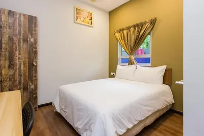 a bedroom with a white bed and a window at Hidden 4BR Cottage House Retreats (Free Parking) in Butterworth
