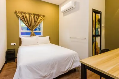 a bedroom with a white bed and a window at Hidden 4BR Cottage House Retreats (Free Parking) in Butterworth
