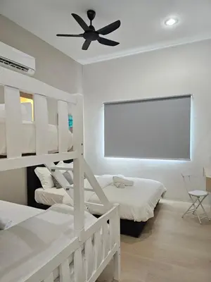 a bedroom with two beds and a ceiling fan at Summer Home 15 Georgetown Adventist in George Town