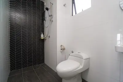a white bathroom with a toilet and a sink at The Horizon Ipoh L15 by Grab A Stay in Ipoh