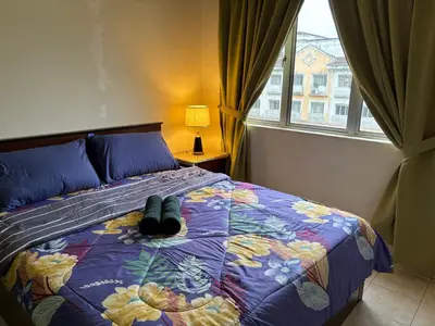 a bed with a pair of shoes sitting on it at Sofea Inn Bukit Merah - Suria A7245 in Simpang Ampat Semanggol