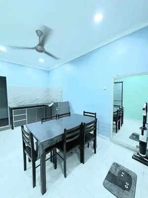 a dining room with a table and some chairs at Shan Homestay in Sungai Petani