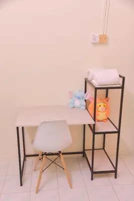 a desk with a chair and a table with toys at The Karaoke Homes Ipoh, Oldtown in Ipoh