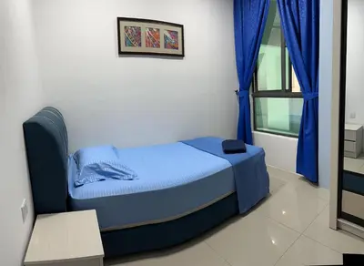 a bedroom with a bed with blue sheets and a window at Eijaz Homestay @ Casa Kayangan in Ipoh