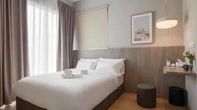a hotel room with a bed and a window at La Vie Hotel Juru in Simpang Ampat