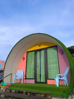 a house with two chairs sitting outside of it at Cameron Highlands Blueberry Earth House in Cameron Highlands