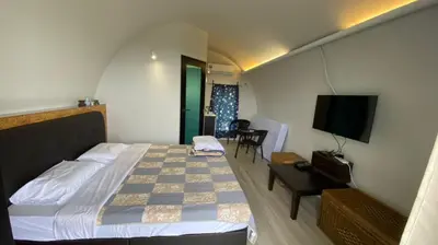 a hotel room with a bed and a television at Cameron Highlands Blueberry Earth House in Cameron Highlands