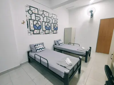 a hospital room with two beds and a painting on the wall at Cozy Home Kampar (UTAR) 5bedrooms 10pax Free WiFi in Kampar