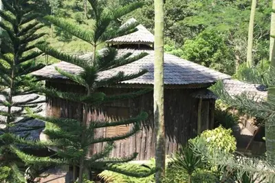 a small building in the middle of a forest at Fig Tree Hills Resort (\u82b1\u679c\u5c71\u5ea6\u5047\u6751) in Bayan Lepas