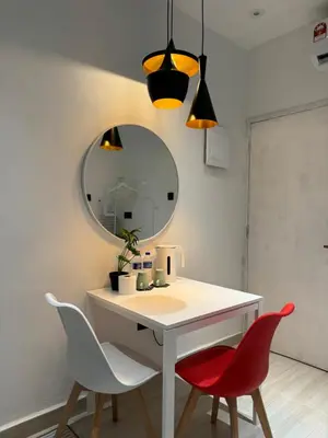 a bathroom with a vanity with two chairs and a mirror at Cozy Scandinavi Guest room - Queen Bed, Free Netflix, Prime & Wi-Fi Near Bukit Mertajam in Kubang Semang