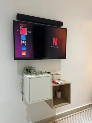 a flat screen tv hanging on a wall at Cozy Scandinavi Guest room - Queen Bed, Free Netflix, Prime & Wi-Fi Near Bukit Mertajam in Kubang Semang