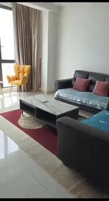 a living room with a couch and a coffee table at jazz suite 2 bedroom sea view apartment in Tanjung Bungah