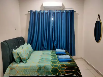 a bedroom with a bed with a blue curtain at Homestay Fayyadh Teluk Intan 3Room2Bath in Teluk Intan