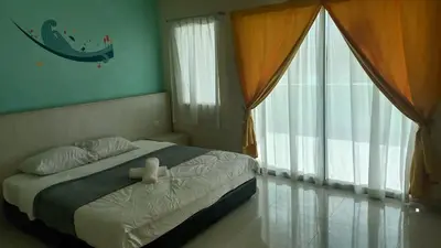a bedroom with a bed and a large window at Laguna Apartment 2, Marina Island Homestay in Kampong Batu Gajah