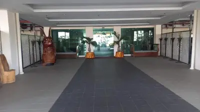 a hallway in a building with orange skirts and windows at Laguna Apartment 2, Marina Island Homestay in Kampong Batu Gajah