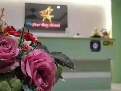 a vase of flowers sitting on a table at Star Bay Hotel in Lumut