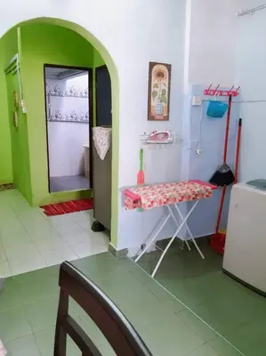a room with a green and white room with a table at Syukur Homestay Ipoh in Ipoh