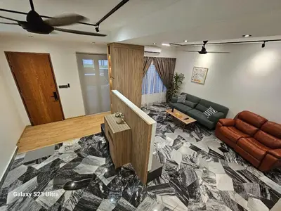 a living room with a couch and a table at Traveler's Stay @ Ipoh (10Pax) in Ipoh
