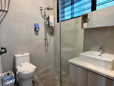 a bathroom with a shower and a toilet and a sink at Traveler's Stay @ Ipoh (10Pax) in Ipoh