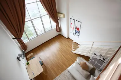 a living room with a large window and a couch at Private Zen at The CEO Bayan Lepas Penang in Bayan Lepas