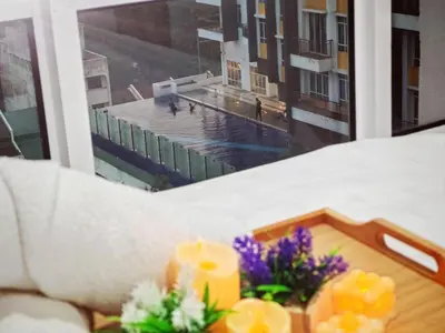 a room with a window with a candle and flowers at Ipoh City Centre Majestic 2 Room Condo near Gerbang Malam by City Home Empire in Ipoh