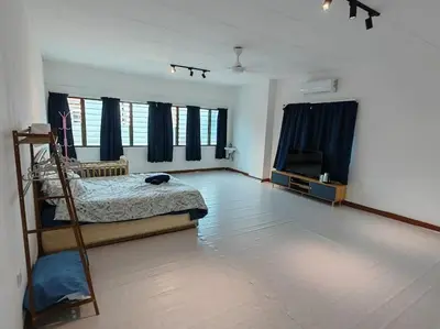 a bedroom with a bed and a television in it at 5-Person 1950s Shophouse Vintage Charm Nflix Disney Plus in Taiping
