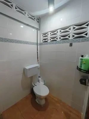 a bathroom with a white toilet in a room at 5-Person 1950s Shophouse Vintage Charm Nflix Disney Plus in Taiping