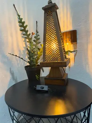 a table with a lamp and a potted plant on it at Stylish Balinimo Guest room - King Bed, Free Netflix, Prime & Wi-Fi Near Bukit Mertajam in Kubang Semang