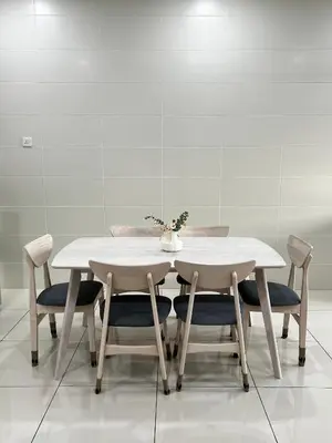 a dining room table with two chairs and a white table at HeyFam Homestay in Sekincan