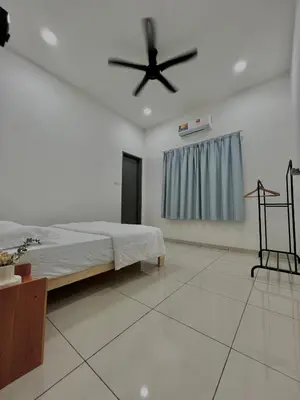 a bedroom with a bed and a ceiling fan at HeyFam Homestay in Sekincan
