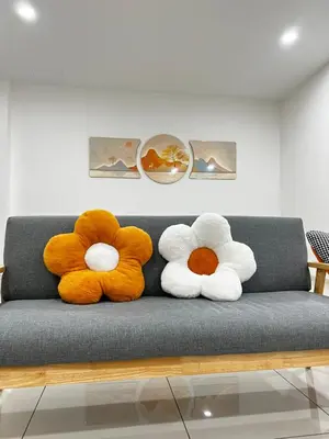 three stuffed animals sitting on a gray couch at HeyFam Homestay in Sekincan