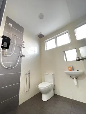 a bathroom with a toilet and a shower and a sink at HeyFam Homestay in Sekincan