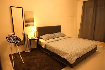 a bedroom with a bed with a mirror and a lamp at Emerald Avenue Brinchang 8 guests 3 bedrooms in Brinchang