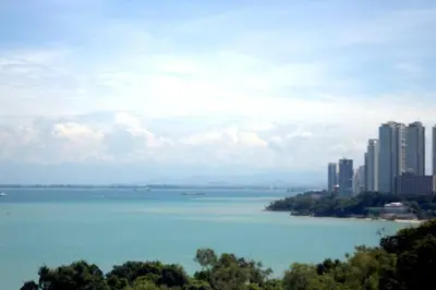 a view of a large body of water with buildings at Shamrock Breeze Villa: Coastal Haven for 29 Guests in Batu Ferringhi