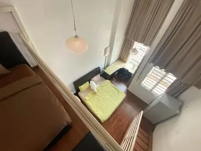 an overhead view of a room with a bed and a living room at Minimalist Duplex @ BayanLepas in Bayan Lepas