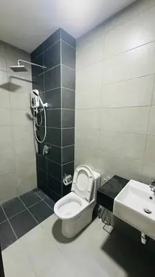 a bathroom with a shower and a toilet and a sink at Deluxe Seaview Georgetown Penang @ ComfyLux Homestay in Jelutong