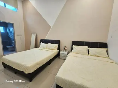 two beds sitting next to each other in a room at Sunway Ipoh - DamaiStay - 5min to Tambun - 20Pax in Tambun
