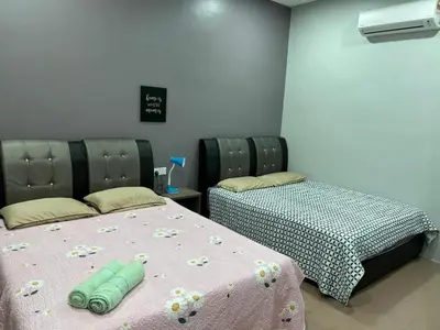 a room with two beds in a room at BOTANI LOFT HOMESTAY in Ipoh