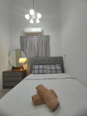 a bedroom with a bed with a towel on it at Ipoh Tambun Sunway next to Heaven Spacious Luxury Home in Kampong Batu Lapan