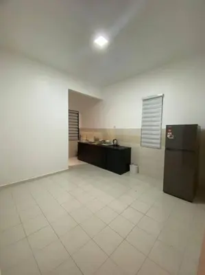 an empty room with a kitchen and a refrigerator at SmartChoice Homestay in Bukit Mertajam