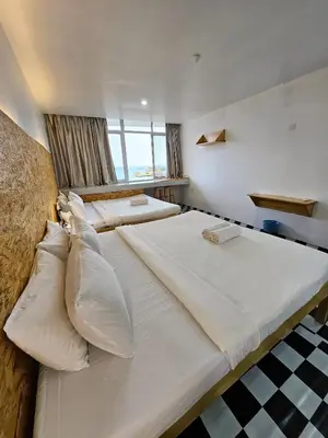 a large white bed with pillows in a room at The 60 in George Town