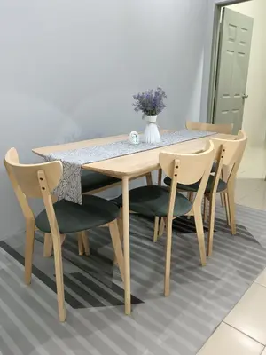 a dining room table and chairs with a vase on it at D’Kayangan Homestay BBSAP Sitiawan in Sitiawan