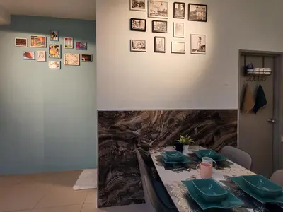a dining room with a table with green dishes on it at INS Pavillion by irainbow in Ipoh